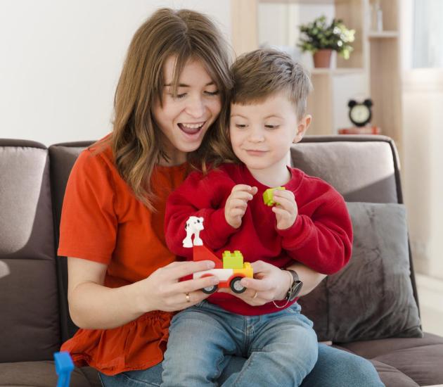 smiley-mother-playing-with-her-son-min smiley-mother-playing-with-her-son-min